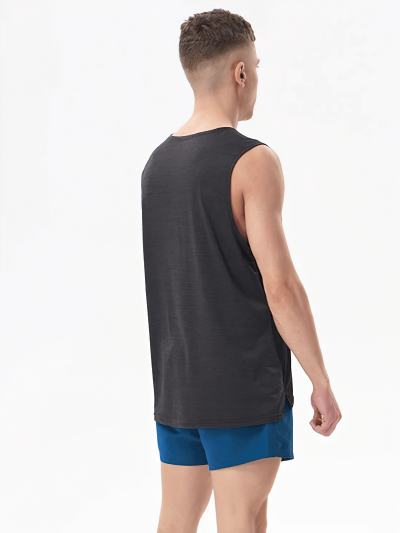 Man wearing a Gym Breathable Double Color Tank Top and blue shorts, showcasing back view. Ideal for workouts with O-neck design.